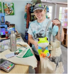 Conservation Education Specialist Tara holding up reusable and eco-friendly products available in the zoo's Nature Store Gift Shop