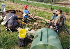Photo of children participating in a nature play activity at the zoo