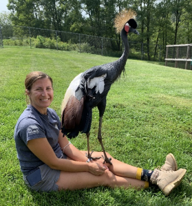 Photo of conservation educator Natalie with a West African Crowned Crane
