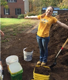 Image of educator Tara standing with full buckets of compost and soil
